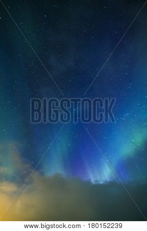 Aurora Borealis Known as Nother Lights Playing with Vivid Colors Over Lofoten Islands in Norway. Vertical Image Composition