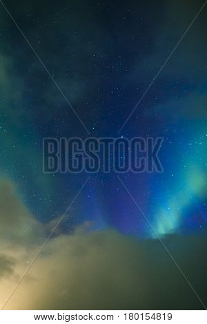 Aurora Borealis Known as Nother Lights Playing with Vivid Colors Over Lofoten Islands in Norway. Vertical Image