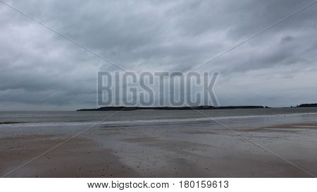 Caldey Island taken from Tenby beach on a cloudy day