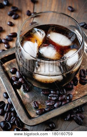 Kahlua liqueur in glasses with coffee beans on a wooden background alcoholic Mexican drink selective focus toned image