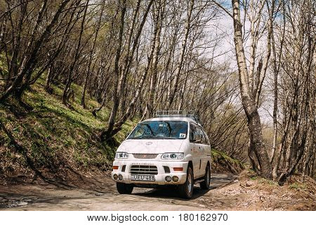 Stepantsminda Gergeti, Georgia - May 23, 2016: Mitsubishi Delica Space Gear on country road in spring mountains landscape. Delica is a range of trucks and multi-purpose vehicles produced by Mitsubishi Motors.