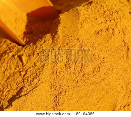 Turmeric Curry Powder Background And A Red Bailer