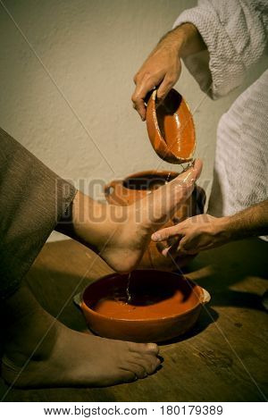 Jesus Christ washing the feet of his apostles in a sign of service and humility