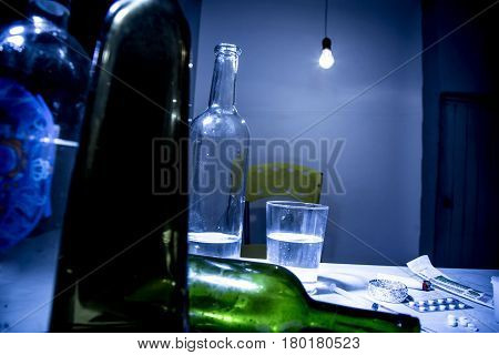 Young man with beard lost in the vices of alcoholism smoking and drug addiction