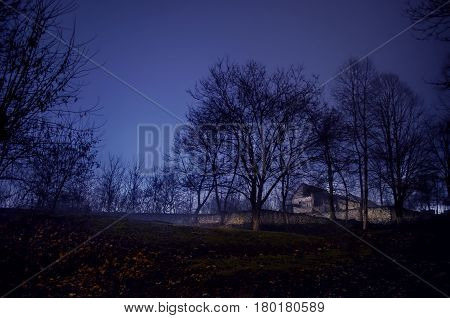 House In Fog At Night In The Garden, Landscape Of Ghost House In The Dark Forest.