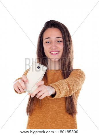 Teenager girl taking a selfie with her mobile isolated on a white background