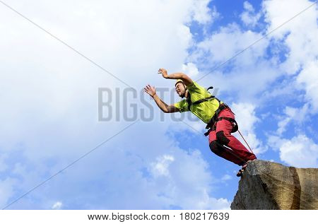 The first jump off the cliff with a safety rope.