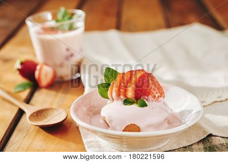 Strawberry short cake with ice-cream on table