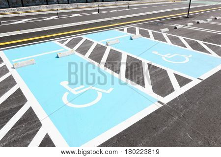 Road marking for handicapped parking stall in a parking lot