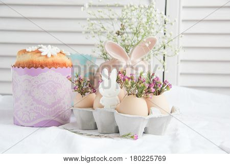 Easter cake in the form of the Easter Bunny and Easter decor with flowers on the table