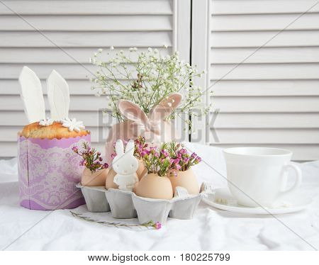 Easter cake in the form of the Easter Bunny and Easter decor with flowers on the table