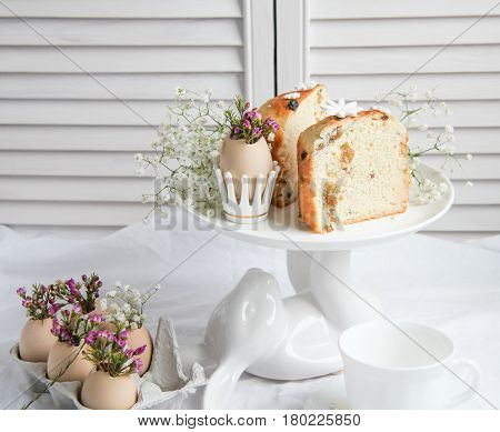 Easter cake in the form of the Easter Bunny and Easter decor with flowers on the table