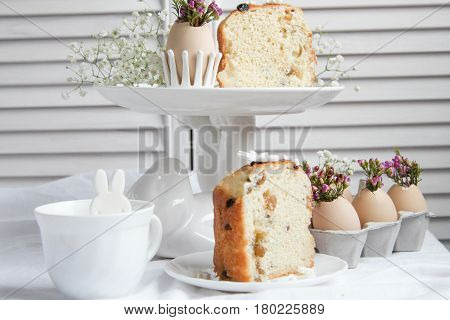Easter cake in the form of the Easter Bunny and Easter decor with flowers on the table