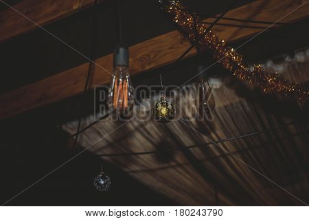 Minimalis. Stylish chandelier in the form of a conventional bulb. Light in the dark. Lighting of the room.