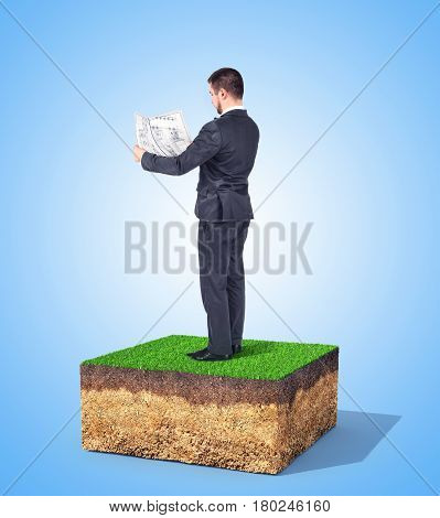 The concept of property. A man with drawing is standing on a piece of land. Concept of planning.