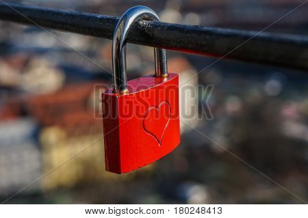 Wedding red lock with heart on a handrail. Symbol of marriage.