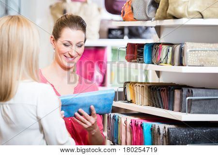 Female customers in store shopping looking for wallets and purses