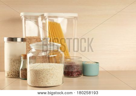 Kitchen containers with groceries on wooden table