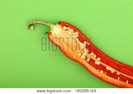 One Cut Red Hot Chili Pepper On Green Background