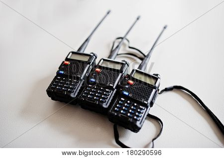 Three Portable Radio Transmitter At Steel Background.