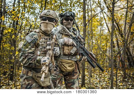 Two United states Marine Corps special operations command Marine Special Operators also known as Marsoc raiders in camouflage uniforms in the forest