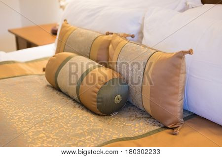 Hotel room setting with king sized bed decorated with pillows in hotel Thailand