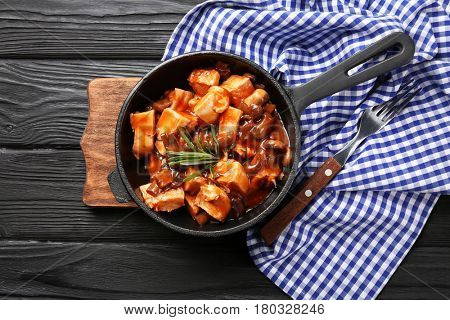 Frying pan with chicken cacciatore on kitchen table