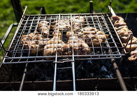 Closeup Of Some Meat Skewers Being Grilled In A Barbecue. Grilling Marinated Shashlik On A Grill.