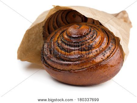 Buns with poppy seads in paper bag isolated on white background