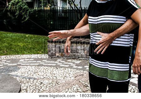 a guy helping a young girl with the heimlich desobstruction while she's choking
