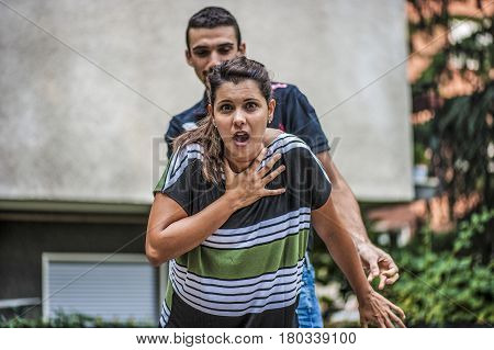 young guy helping a young girl while she's choking