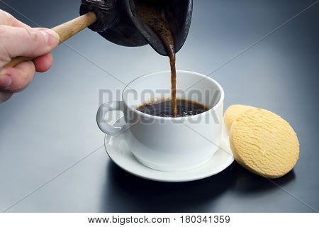 freshly brewed black coffee from the turks poured in a white cup