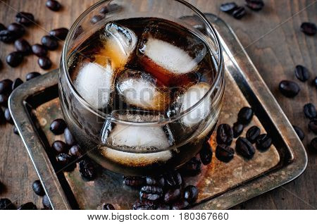 Kahlua liqueur in glasses with coffee beans on a wooden background alcoholic Mexican drink selective focus toned image