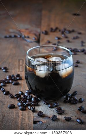Coffee cocktail Black Russian liquor in glasses with coffee beans on a wooden background selective focus toned image