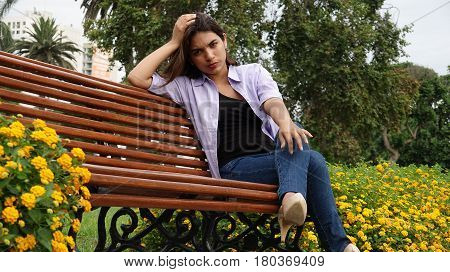 Unhappy Or Serious Teen Girl Sitting On Park Bench