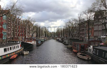 Amsterdam in April 2016. Netherlands. Amsterdam cityscape with houseboats.