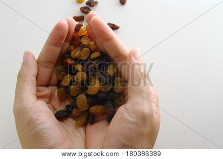 Raisin / A raisin is a dried grape. Raisins are produced in many regions of the world and may be eaten raw or used in cooking, baking, and brewing