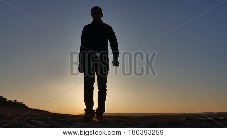 freedom. Man stands on cliff sunset silhouette hand lifestyle in the sides