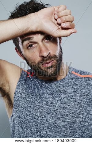 Hot guy wiping sweat from brow portrait