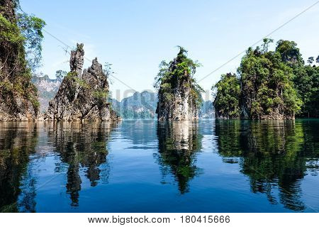Three Moutains Island With Green Tree And Blue Sky At Ratchaprapa Dam In Thailand, Mirror Or Shadow