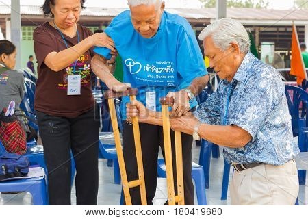 CHIANG RAI THAILAND - FEBRUARY 20 : unidentified couple helping leprosy asian old man on February 20 2016 in Chiang rai Thailand.