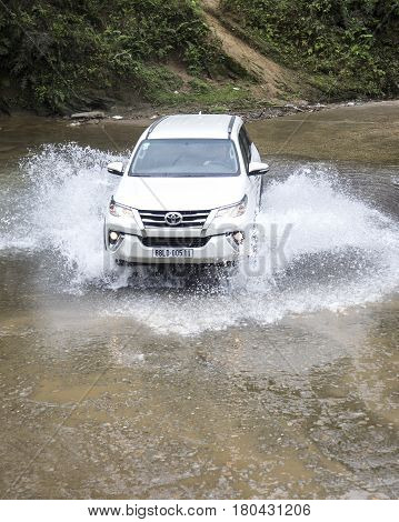 Lao Cai, Vietnam - Mar 17, 2017: Toyota Fortuner 2017 SUV in a test drive for ability on multi terrains in the far north of Vietnam.