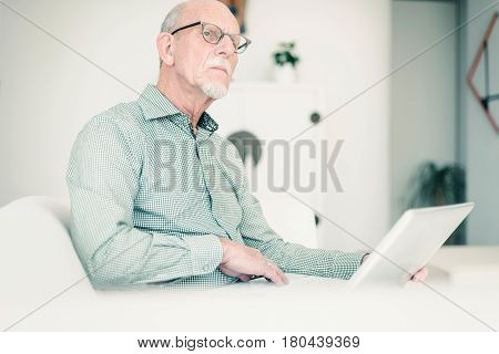 Pensive Man With Laptop On Couch At Home.