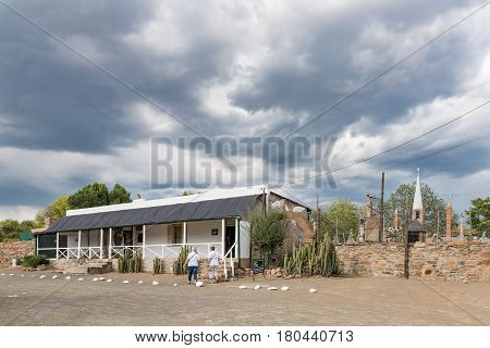 NIEU BETHESDA SOUTH AFRICA - MARCH 21 2017: Unidentified tourists at the Owl House museum in Nieu-Bethesda an historic village in the Eastern Cape Province