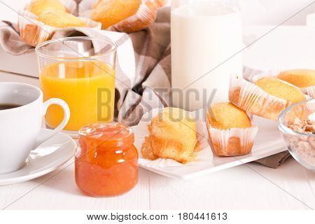 Breakfast with plumcake and cup coffee on wooden table.