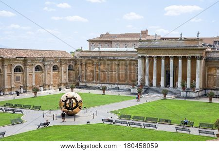 VATICAN CITY ITALY - July 26 2015: Belvedere Courtyard at the Vatican which contains the Sphere Within A Sphere sculpture by Italian sculptor Arnaldo Pomodoro. Different versions of the bronze globe can be found around the world.