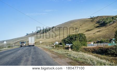 The road near the village in a mountainous area. View from the car