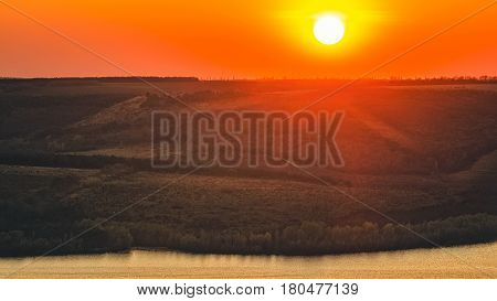 Sunset scenery on the Dniester river with sun and red evening sky national park Podillya Tovtry Ukraine
