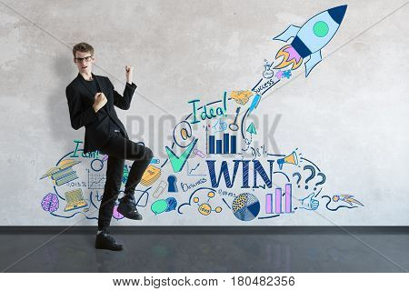 Young businessman celebrating success in concrete interior with spaceship sketch. Startup concept. 3D Rendering