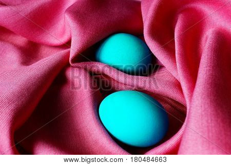 Painted  Easter eggs on red fabric background.